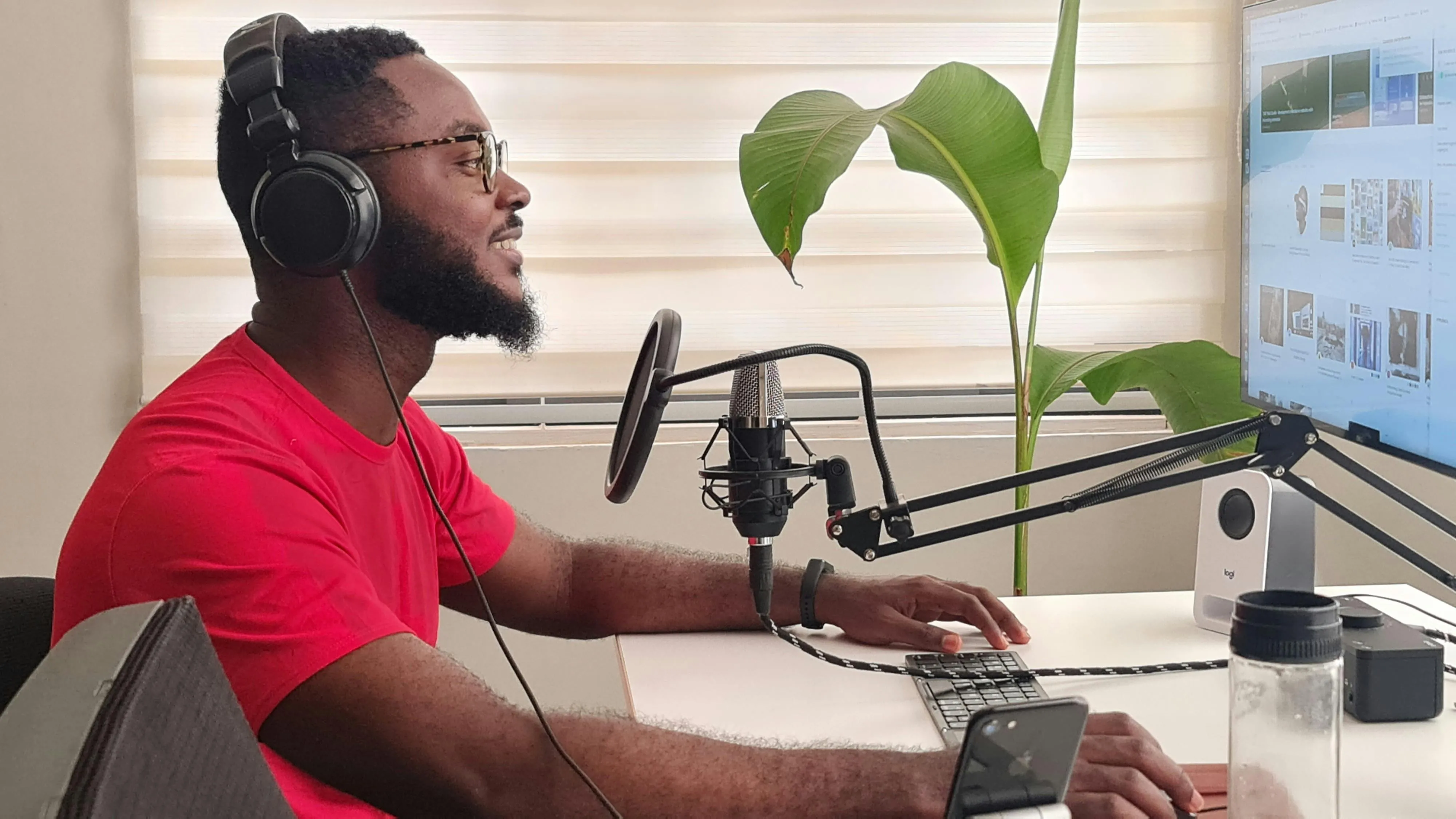 A man wearing headphones recording his screen for educational content.