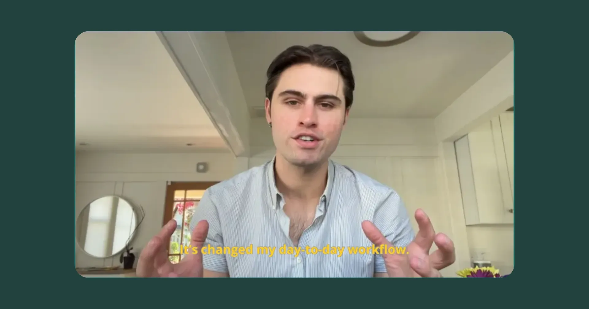 A man speaks into a camera while gesturing with his hands.