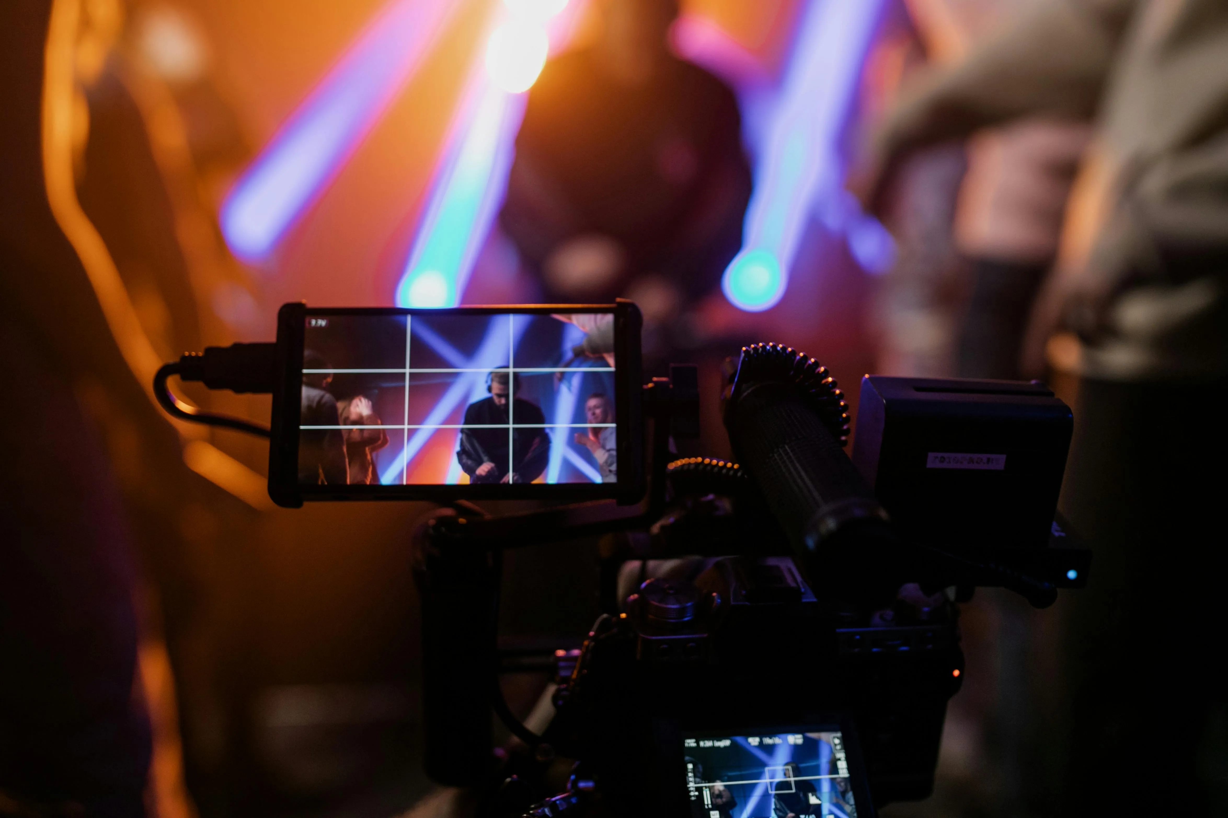 A camera filming a live event with the background out of focus.