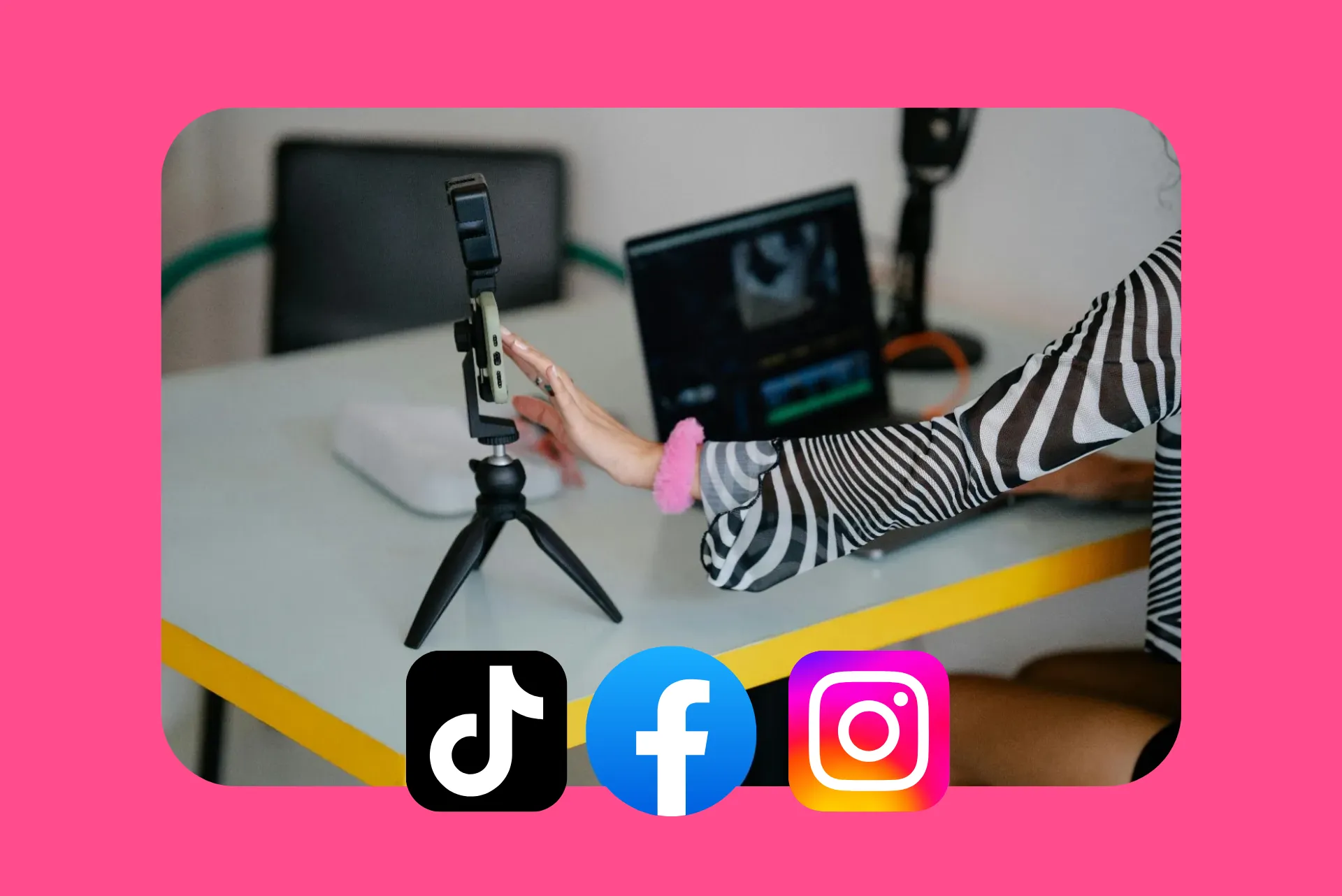 A woman's hand reaching out to touch a mobile phone on a tripod.